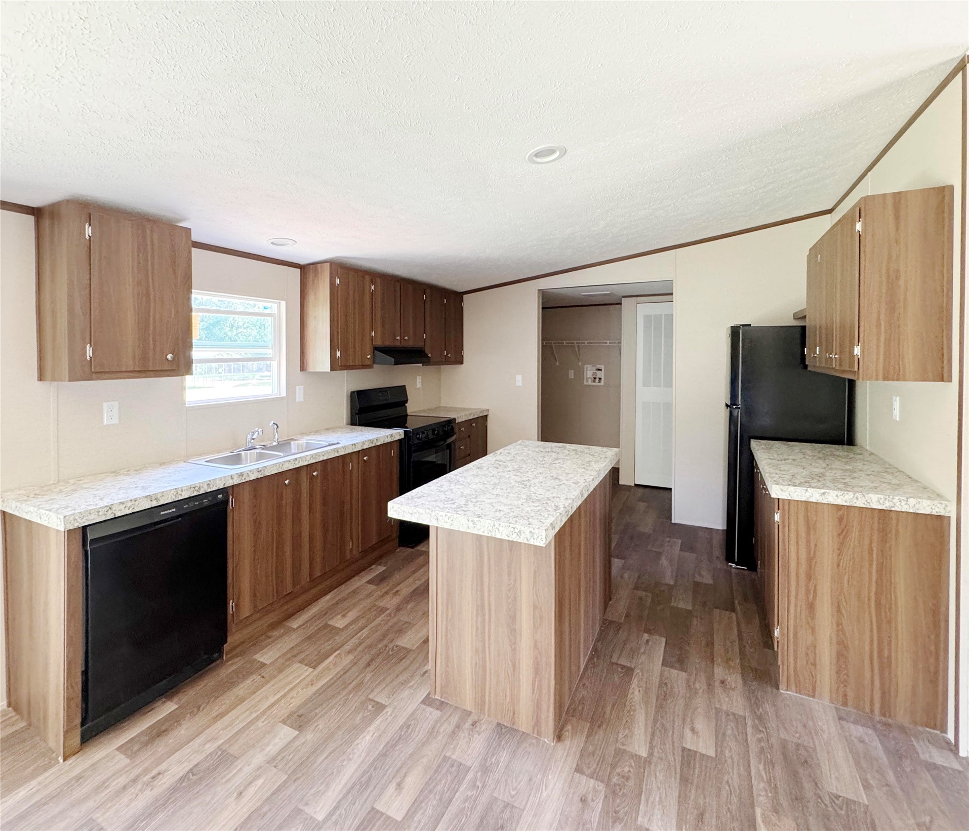 26817 Long Street Splendora, TX 77372 - Photo 8 of 18 a kitchen with a sink a stove a refrigerator and a microwave