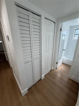 a view of hallway with wooden floor