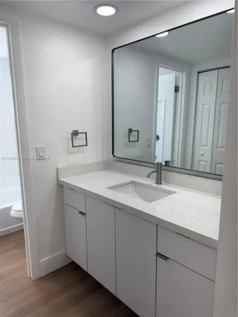a utility room with wooden floor washer and dryer