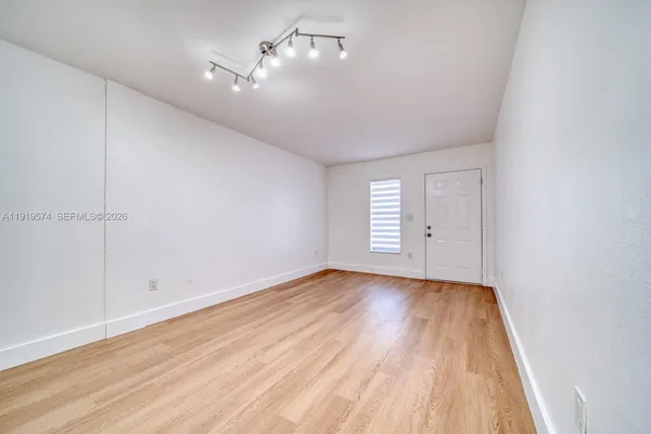 a kitchen with stainless steel appliances granite countertop a sink and dishwasher a stove top oven with white cabinets