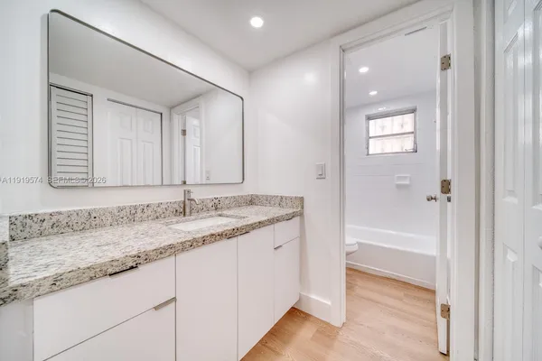 a bathroom with a bathtub a toilet and a shower