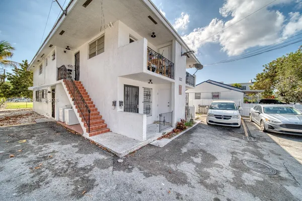 a front view of a house with parking area