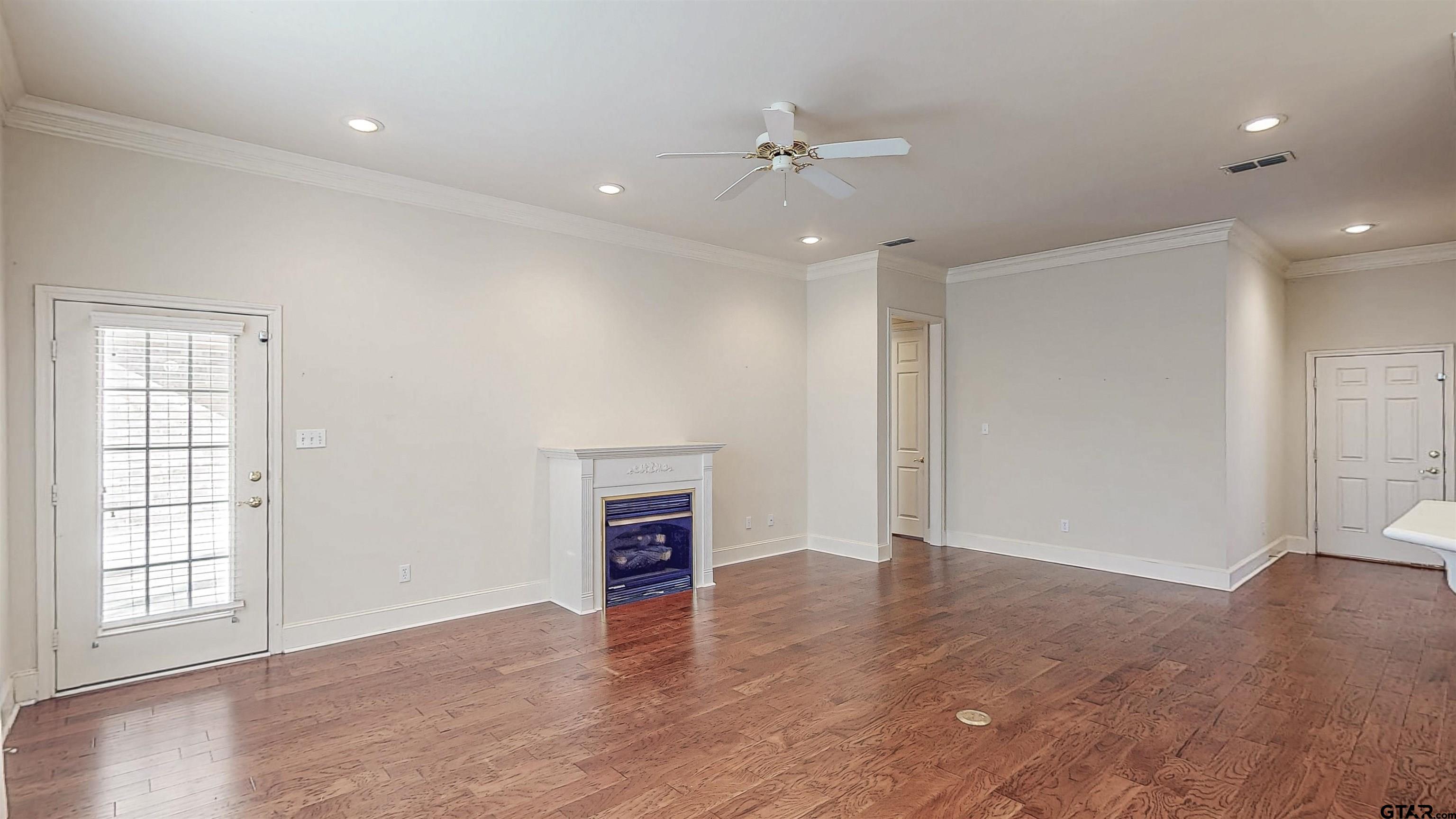 2435 Homestead Lane Tyler, TX 75701 - Photo 12 of 35 an empty room with wooden floor and windows