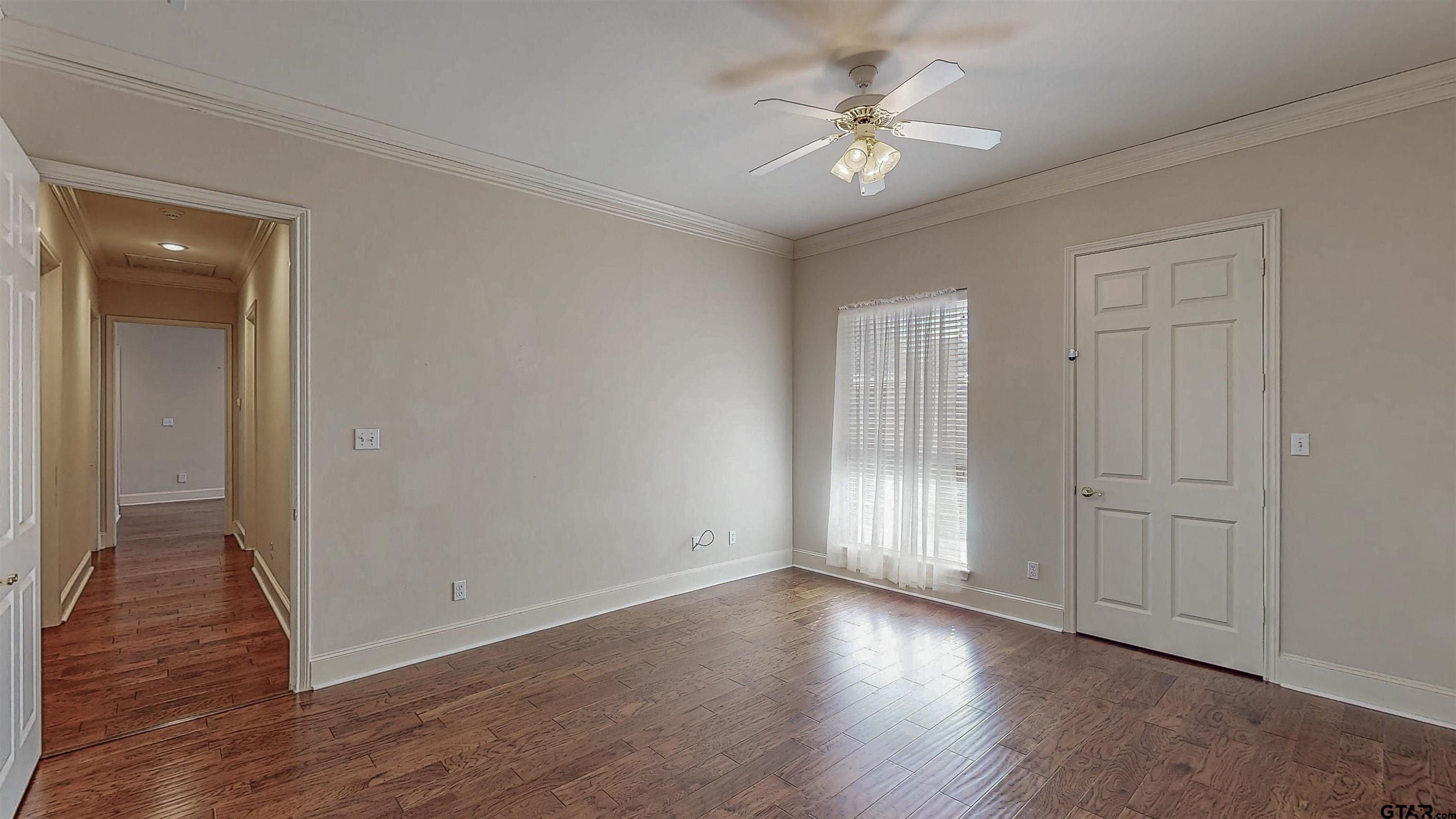 2435 Homestead Lane Tyler, TX 75701 - Photo 14 of 35 wooden floor in an empty room with a window