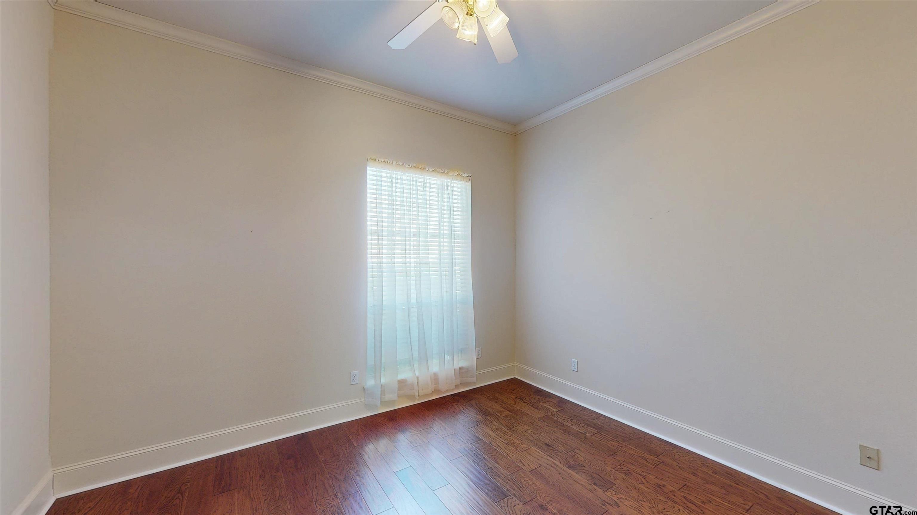 2435 Homestead Lane Tyler, TX 75701 - Photo 19 of 35 a view of an empty room with wooden floor and a window