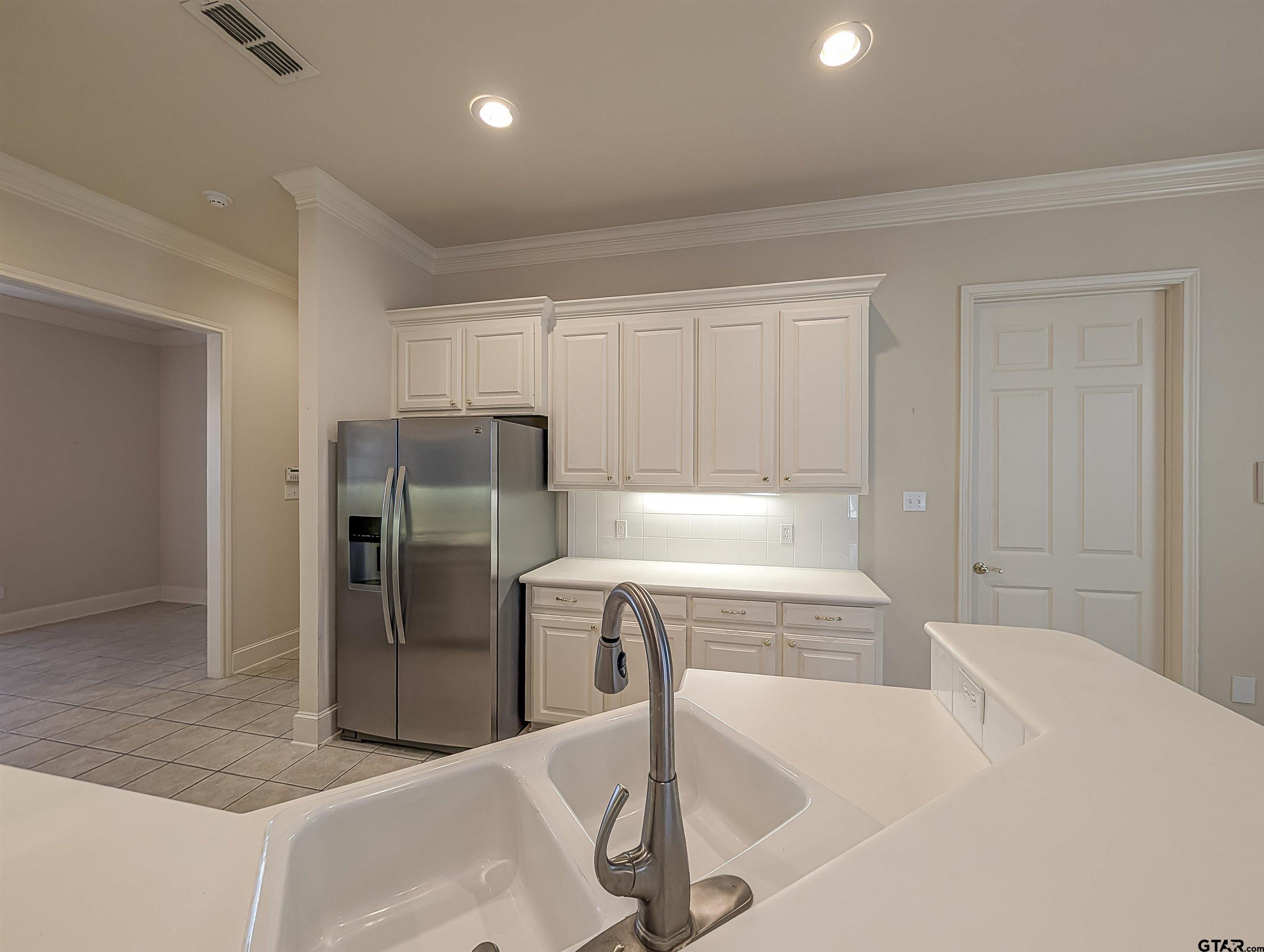 2435 Homestead Lane Tyler, TX 75701 - Photo 3 of 35 a kitchen with stainless steel appliances granite countertop a sink and a refrigerator