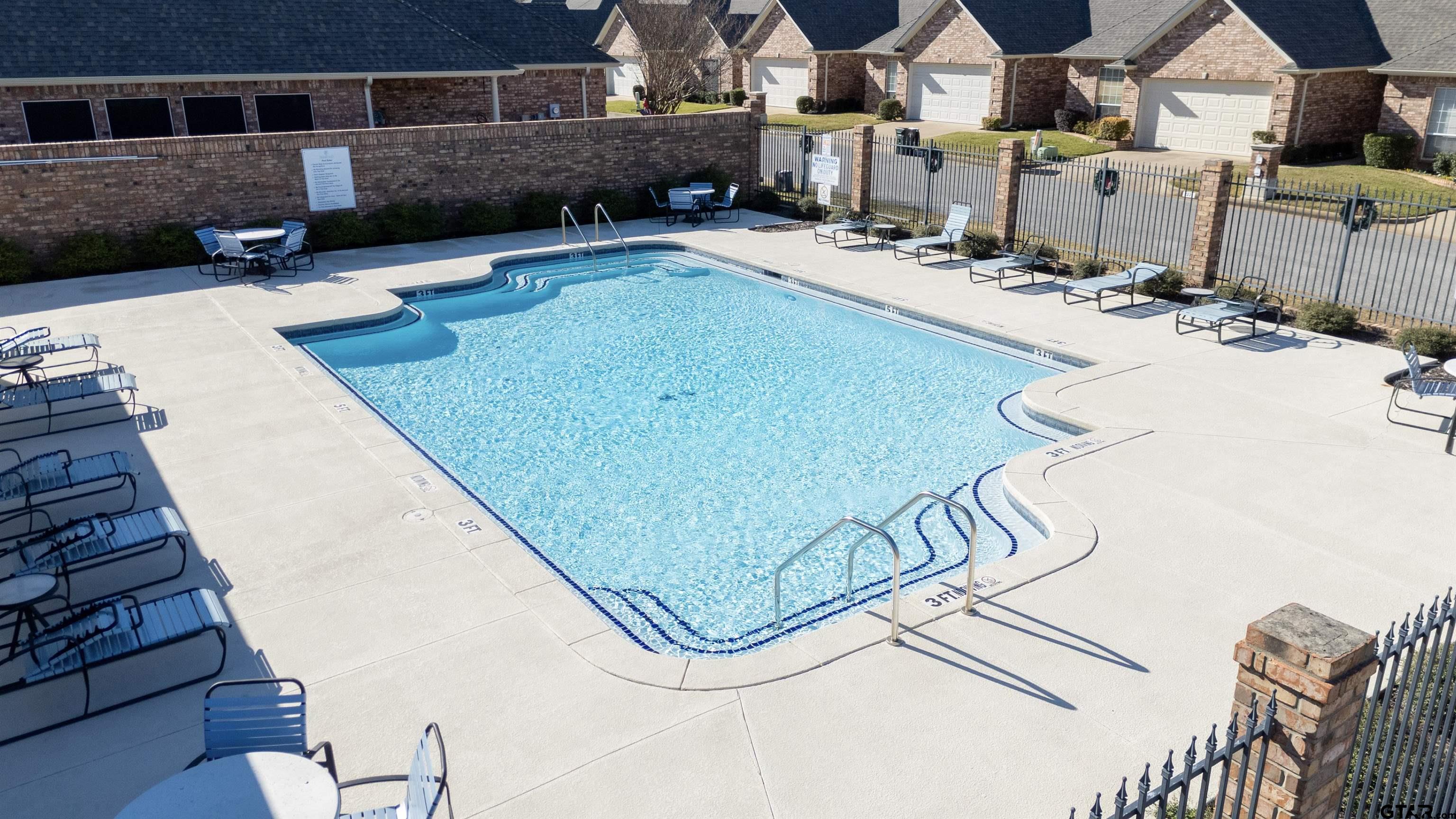 2435 Homestead Lane Tyler, TX 75701 - Photo 35 of 35 a view of a swimming pool with a patio