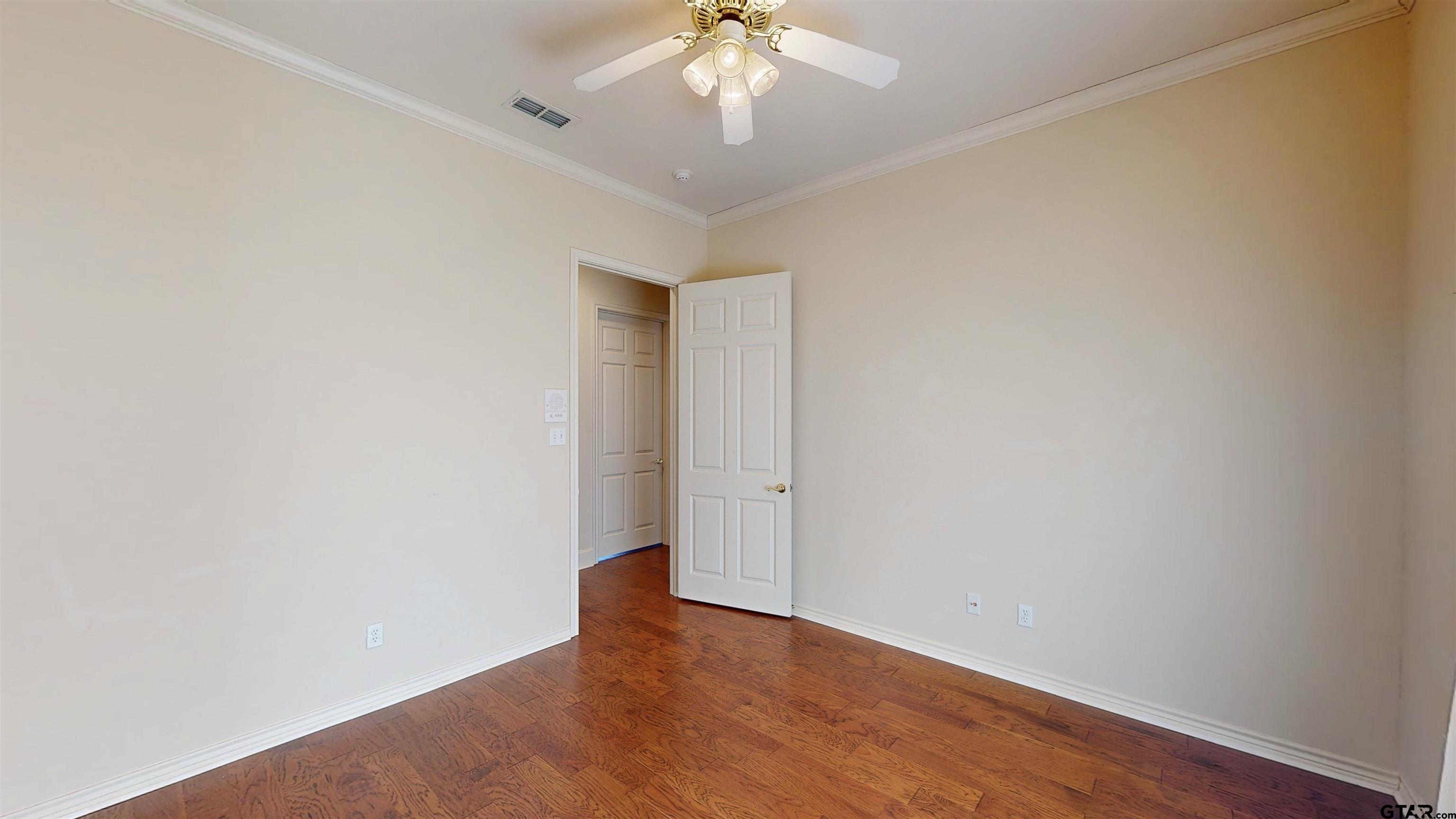 2435 Homestead Lane Tyler, TX 75701 - Photo 8 of 35 a view of an empty room with a window and wooden floor