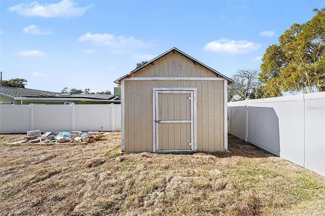 a view of a white house with a yard and garage
