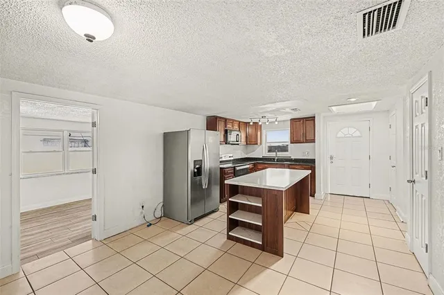 a kitchen with granite countertop a sink and a stove top oven