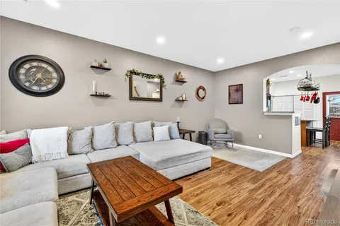 a living room with furniture a rug and a wall painting