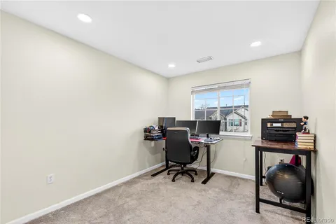 a view of a dining room with furniture and a chandelier