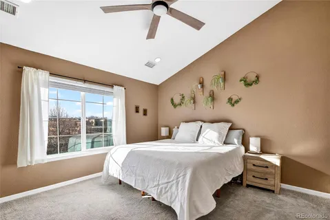 a spacious bedroom with a large bed and a couch