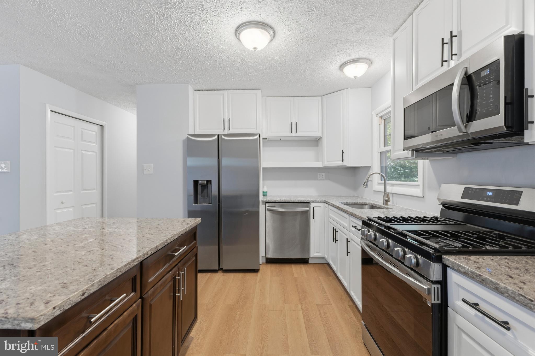 119 Jefferson Road Waldorf, MD 20602 - Photo 4 of 40 a kitchen with stainless steel appliances granite countertop a stove microwave sink and refrigerator