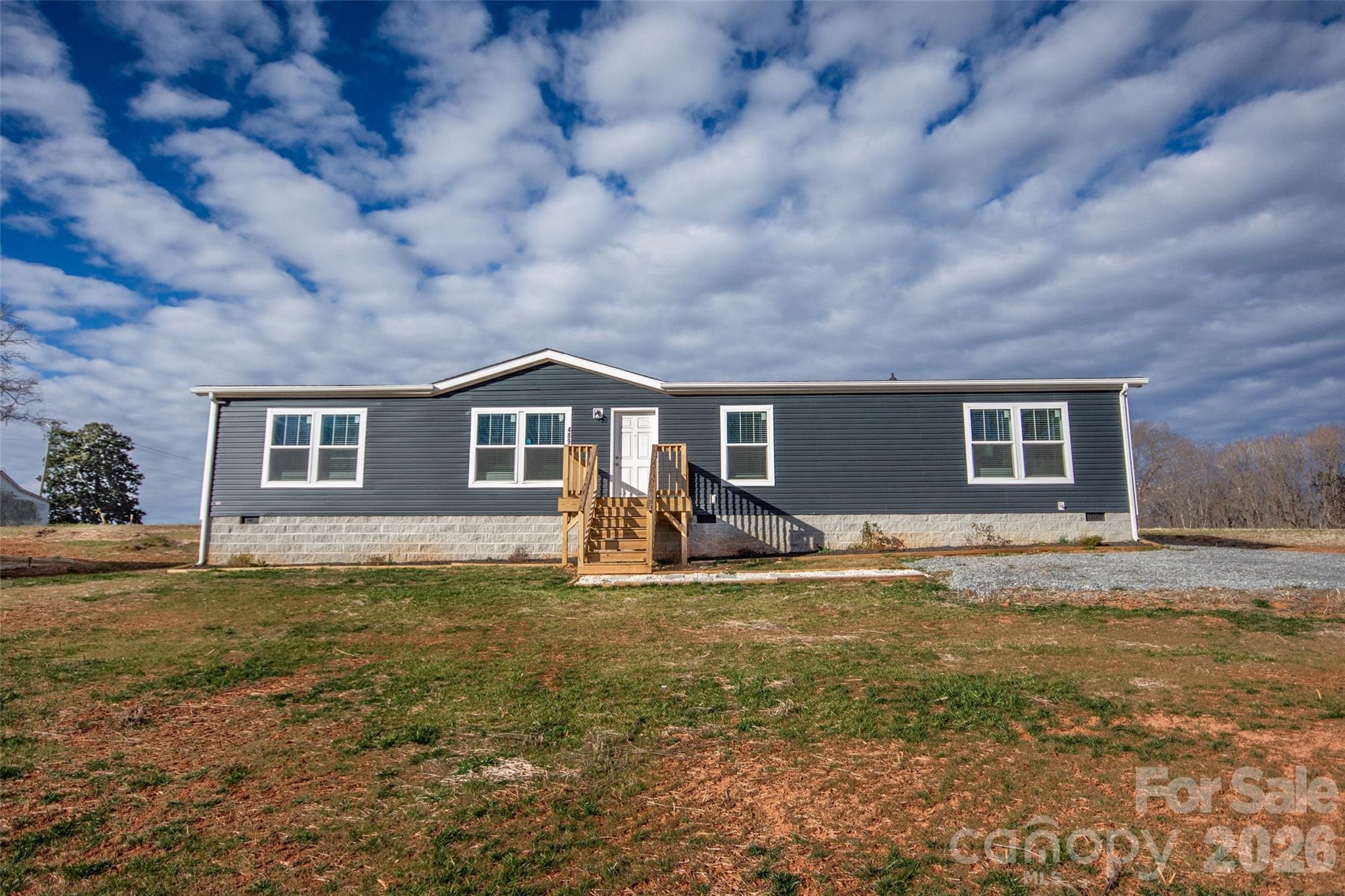 489 Eagle Mills Road Hamptonville, NC 27020 - Photo 1 of 24 a front view of a house with a yard