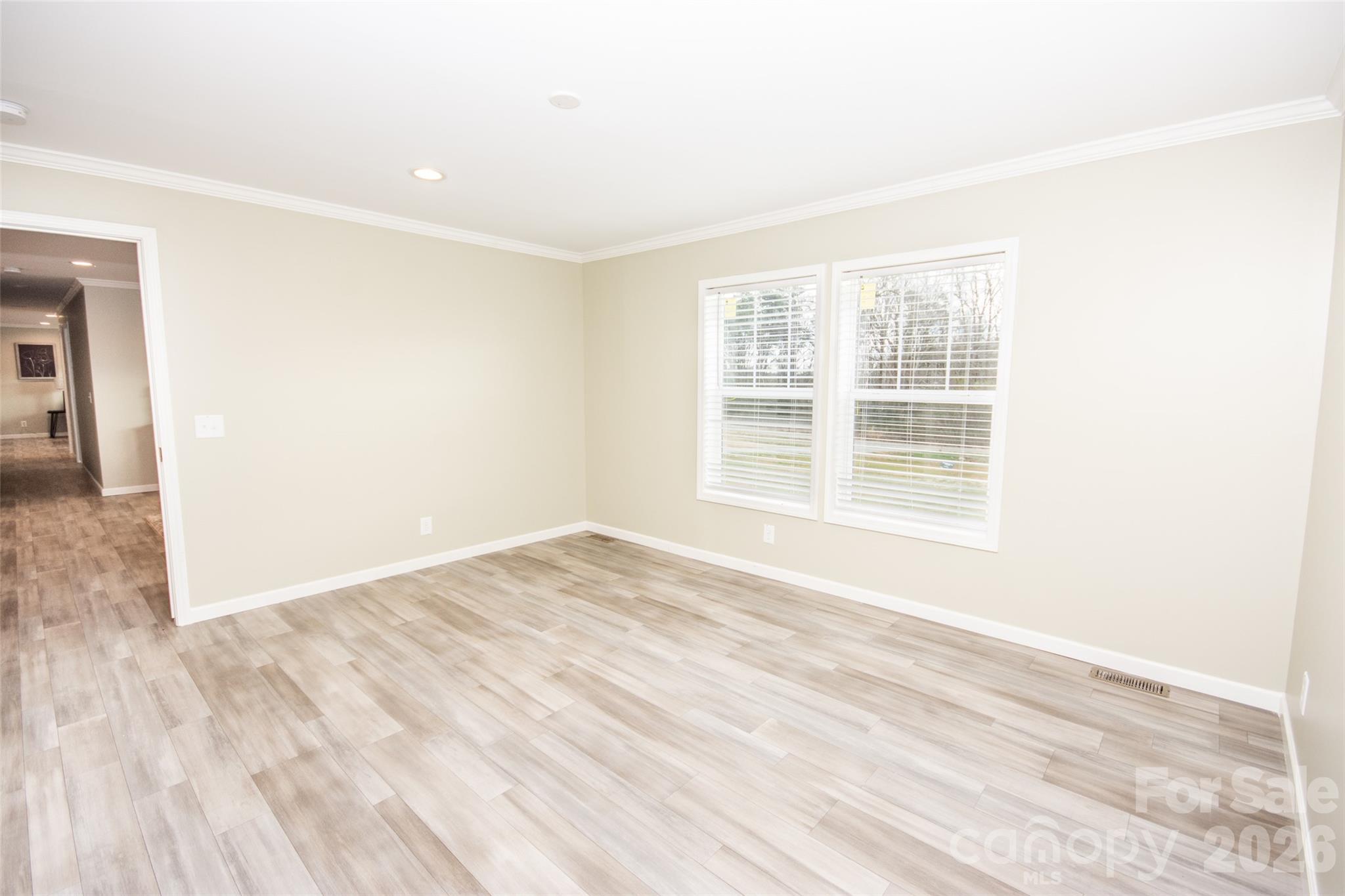 489 Eagle Mills Road Hamptonville, NC 27020 - Photo 11 of 24 an empty room with wooden floor and windows
