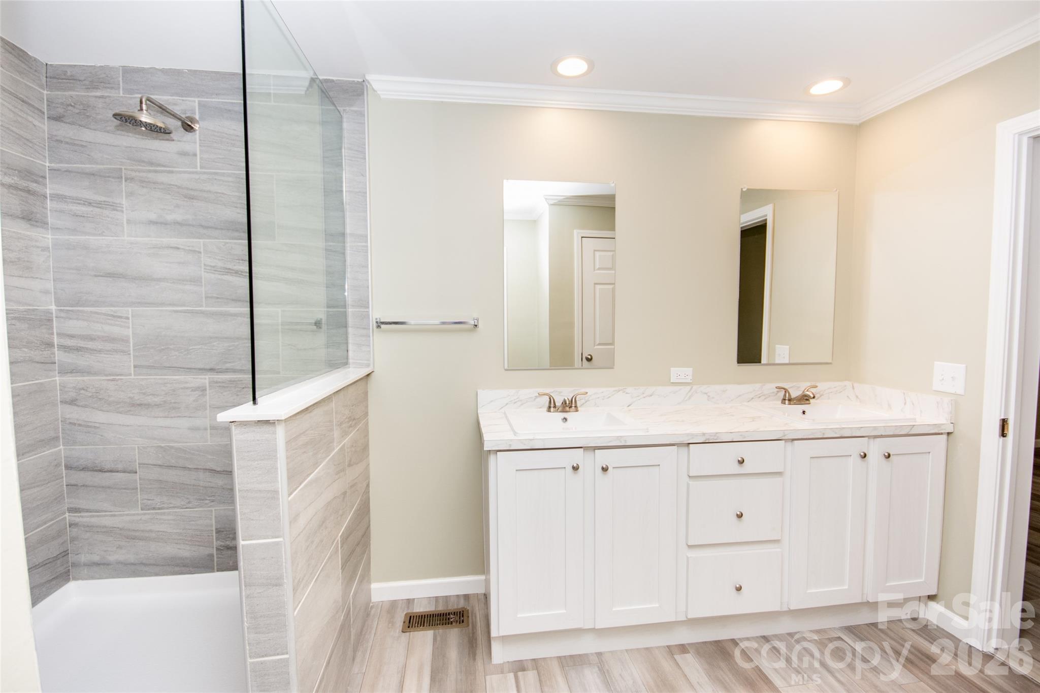 489 Eagle Mills Road Hamptonville, NC 27020 - Photo 15 of 24 a bathroom with a double vanity sink a mirror and a shower