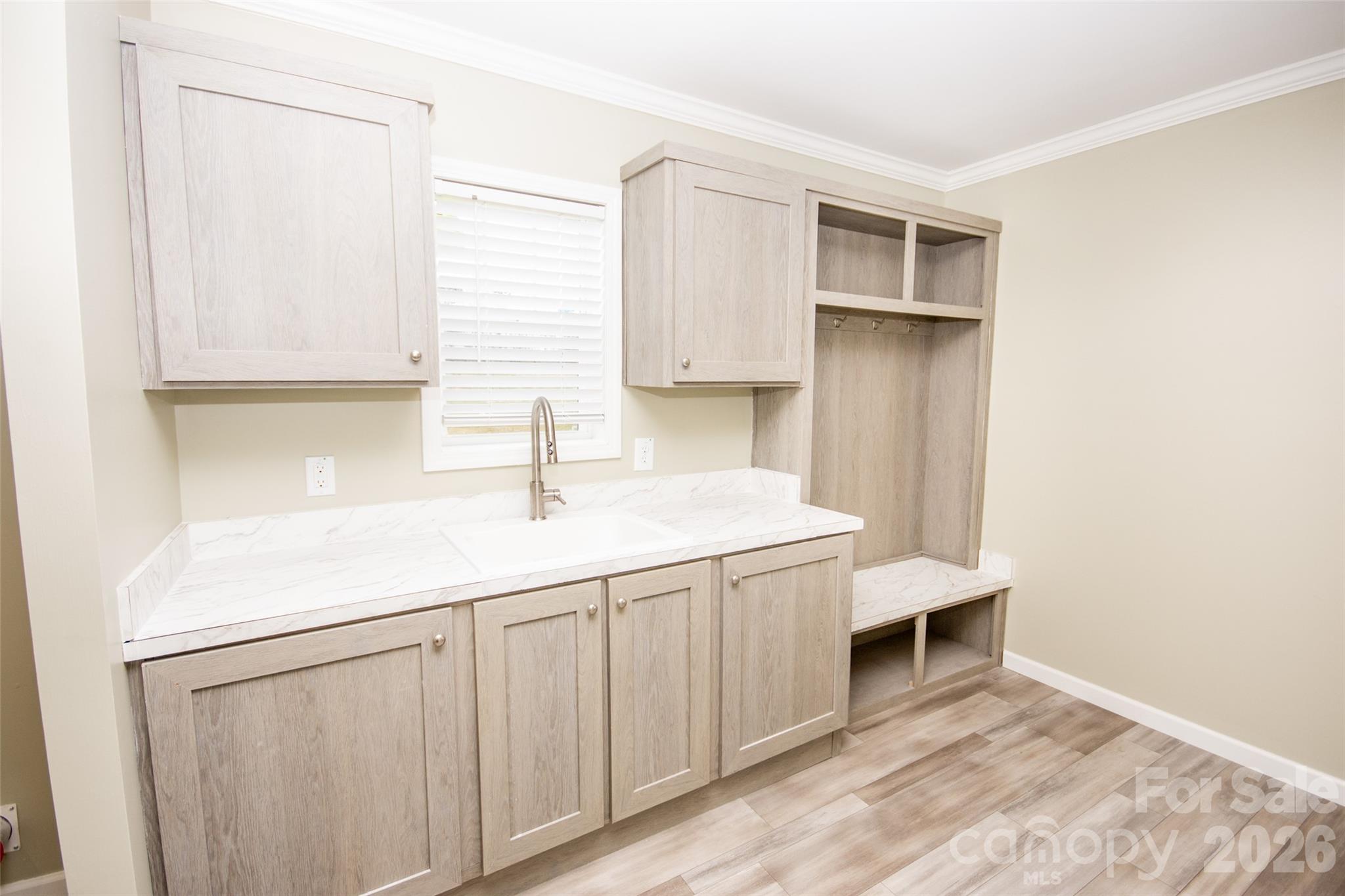 489 Eagle Mills Road Hamptonville, NC 27020 - Photo 16 of 24 a kitchen with white cabinets a sink and dishwasher