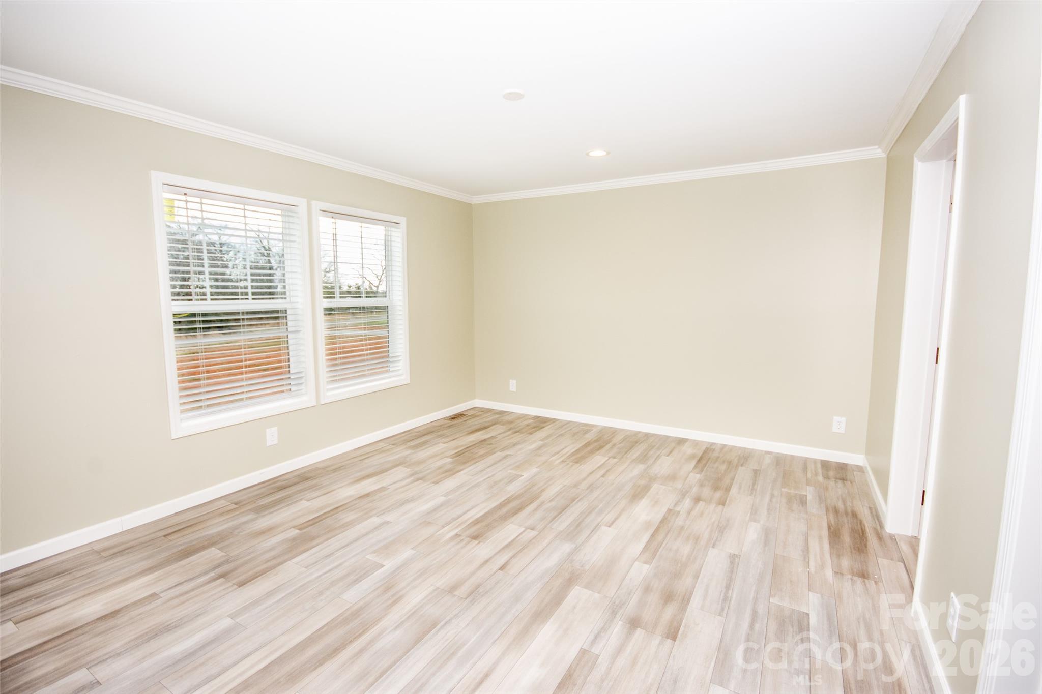 489 Eagle Mills Road Hamptonville, NC 27020 - Photo 18 of 24 a view of an empty room with wooden floor and a window