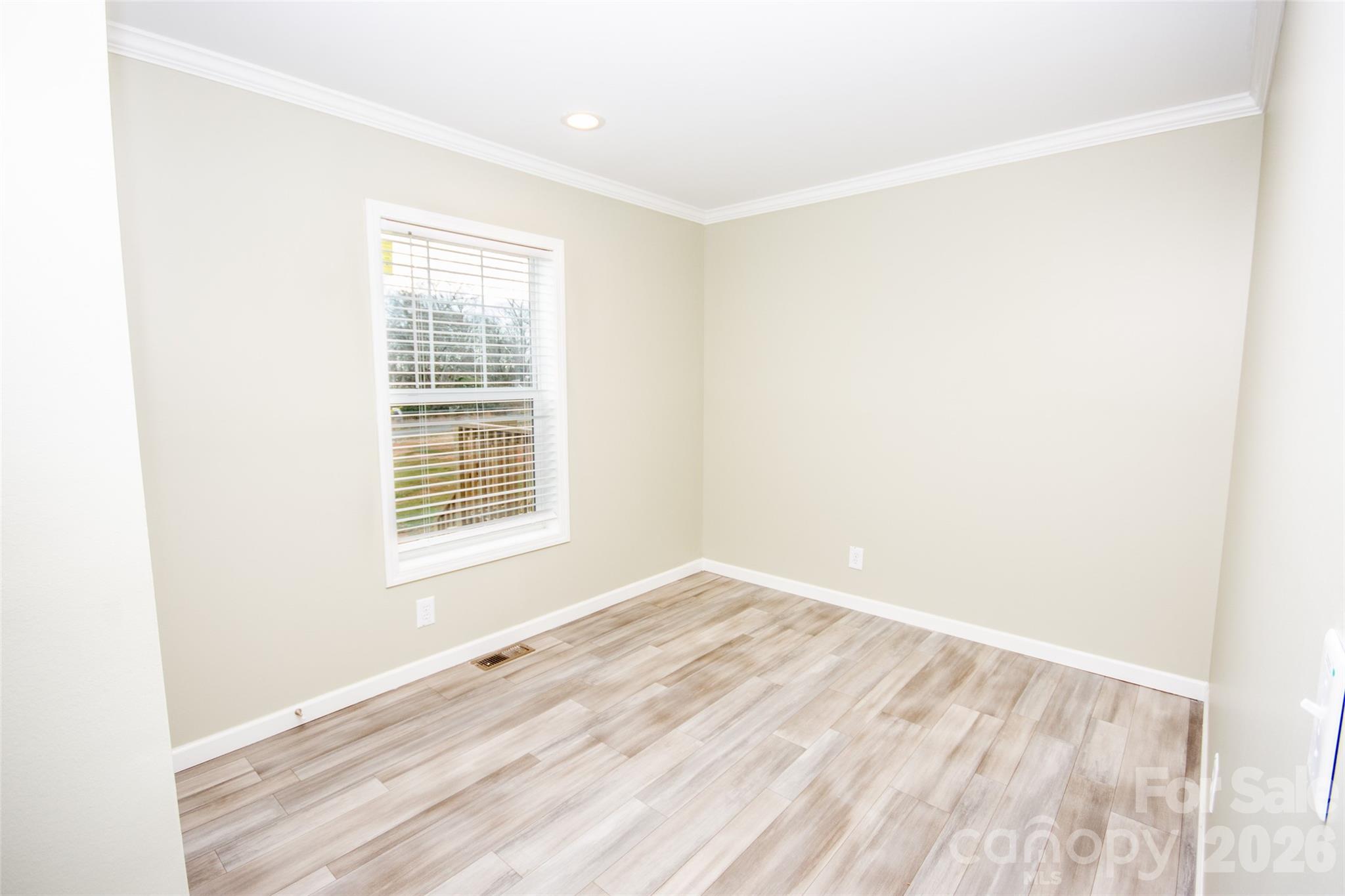 489 Eagle Mills Road Hamptonville, NC 27020 - Photo 20 of 24 a view of an empty room with wooden floor and a window