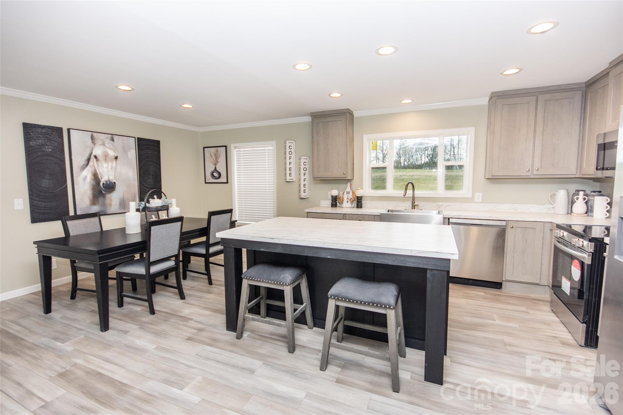 489 Eagle Mills Road Hamptonville, NC 27020 - Photo 5 of 24 a view of a dining room with furniture and wooden floor