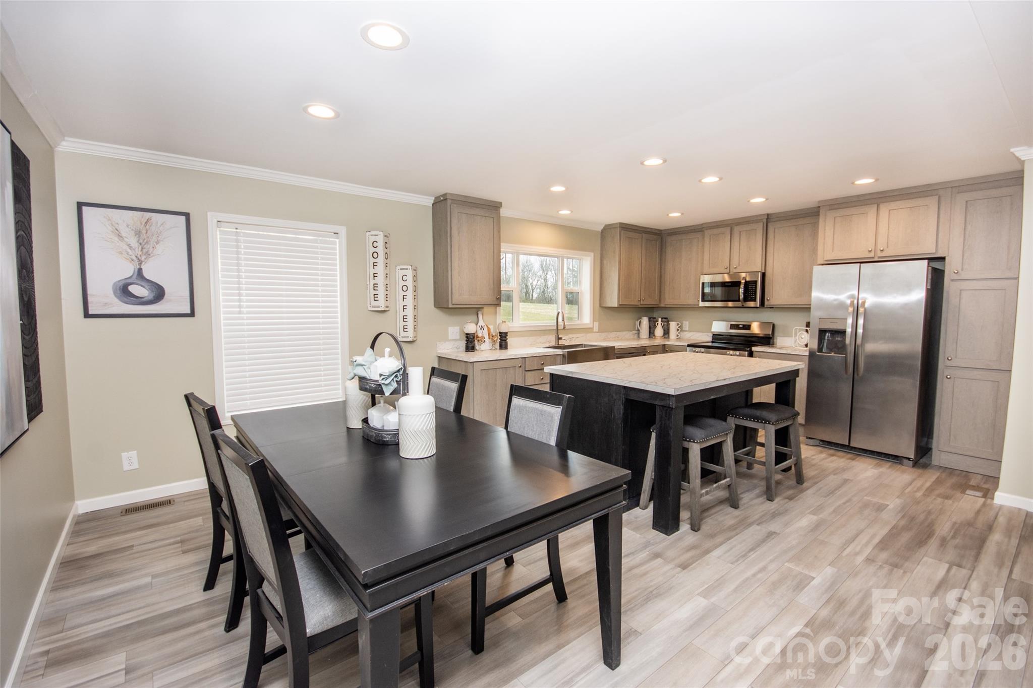 489 Eagle Mills Road Hamptonville, NC 27020 - Photo 6 of 24 a kitchen with a dining table chairs and refrigerator