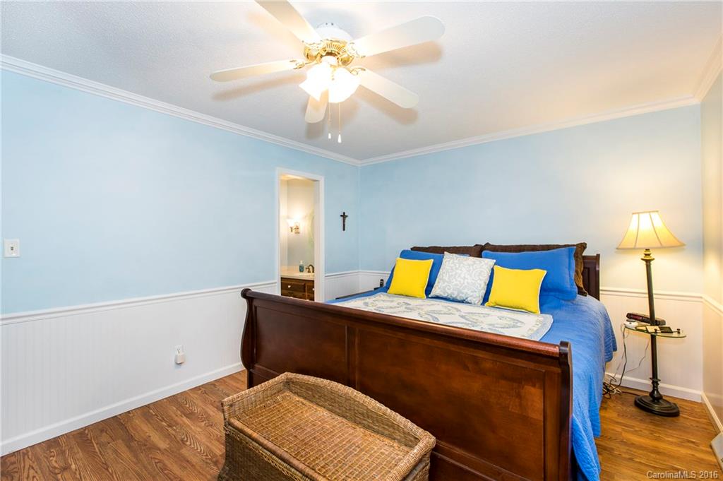 1610 Dunlap Roddey Road Rock Hill, SC 29730 - Photo 13 of 24 a bedroom with a bed and a chandelier