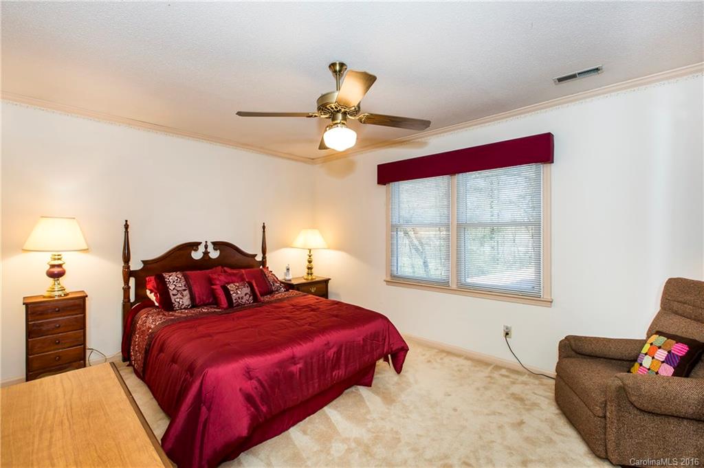 1610 Dunlap Roddey Road Rock Hill, SC 29730 - Photo 19 of 24 a bedroom with a bed and a chandelier