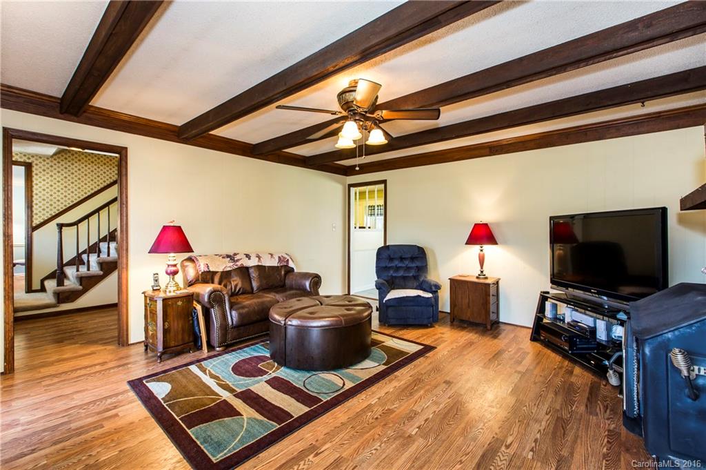 1610 Dunlap Roddey Road Rock Hill, SC 29730 - Photo 4 of 24 a living room with furniture a flat screen tv and a dining table with wooden floor