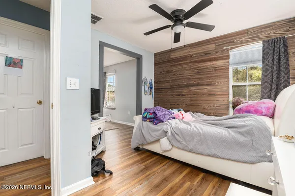 a bedroom with a bed and a chandelier