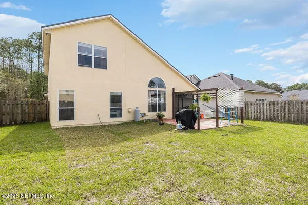a view of a house with backyard porch and garden