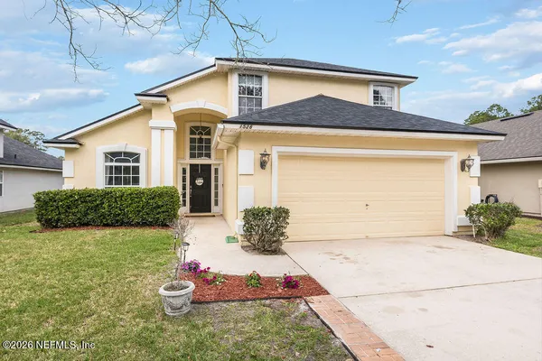 a front view of a house with a yard