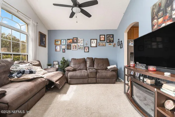 a living room with furniture and a flat screen tv