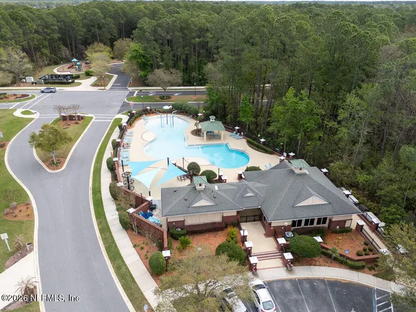 an aerial view of a house with garden space and lake view