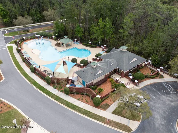 an aerial view of a house with pool table and chairs
