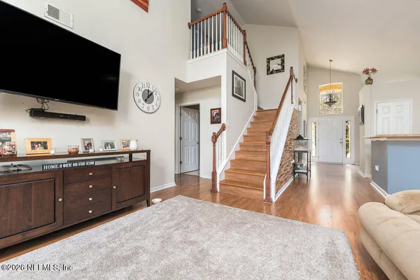 a living room with furniture and a flat screen tv