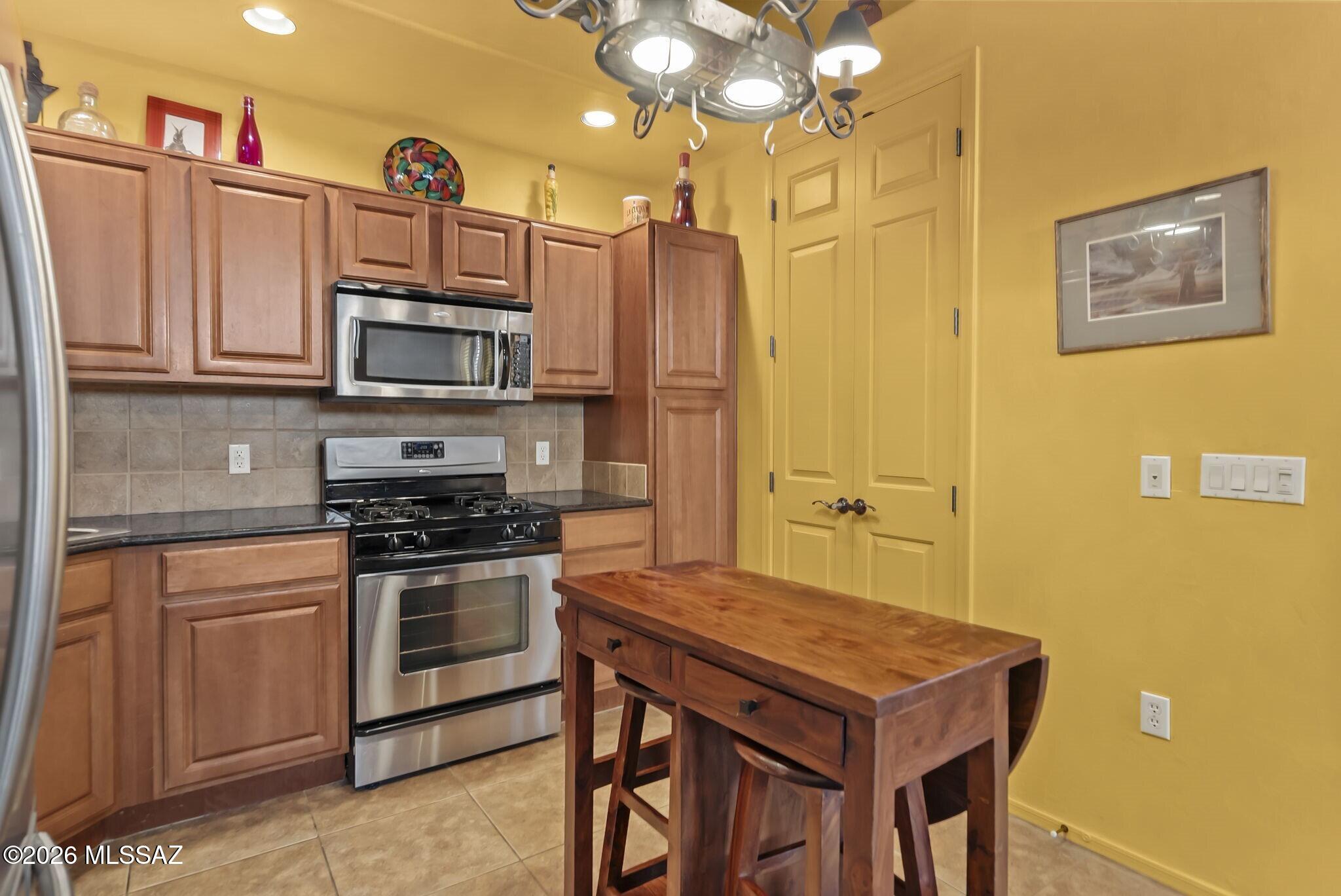 101 Post Way Tubac, AZ 85646 - Photo 10 of 31 a kitchen with stainless steel appliances a stove a refrigerator and a cabinets