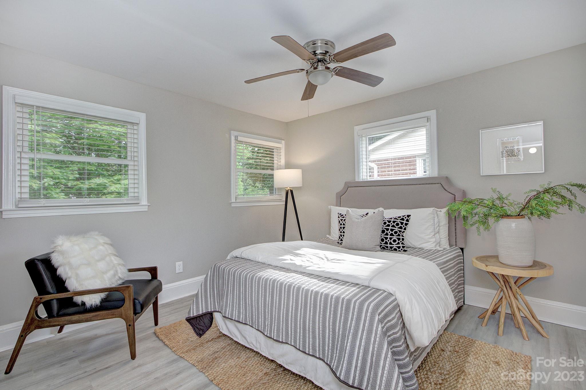 2954 Enfield Road Charlotte, NC 28205 - Photo 11 of 27 a bedroom with a bed and a chair