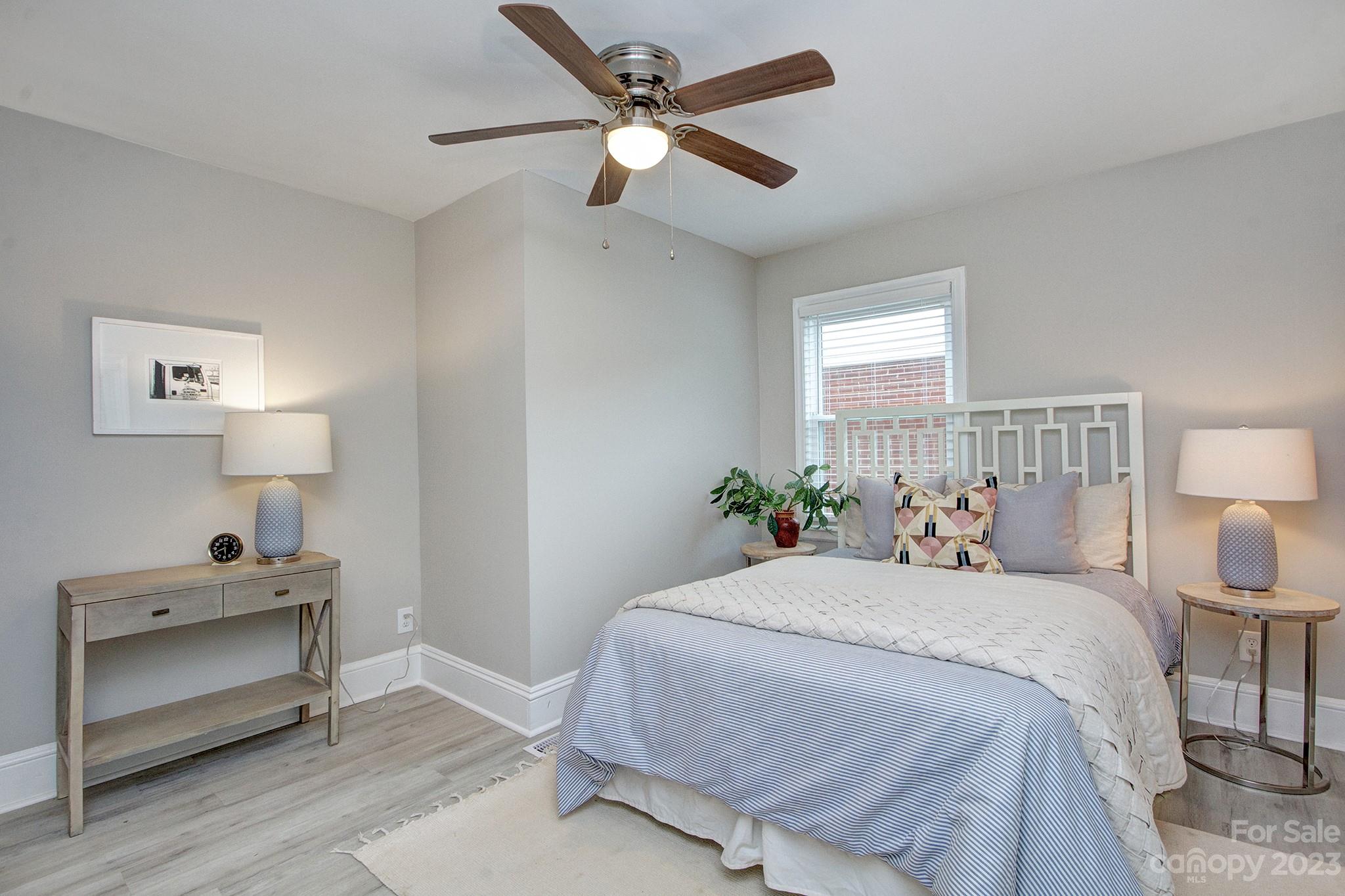 2954 Enfield Road Charlotte, NC 28205 - Photo 15 of 27 a bedroom with a bed and a lamp