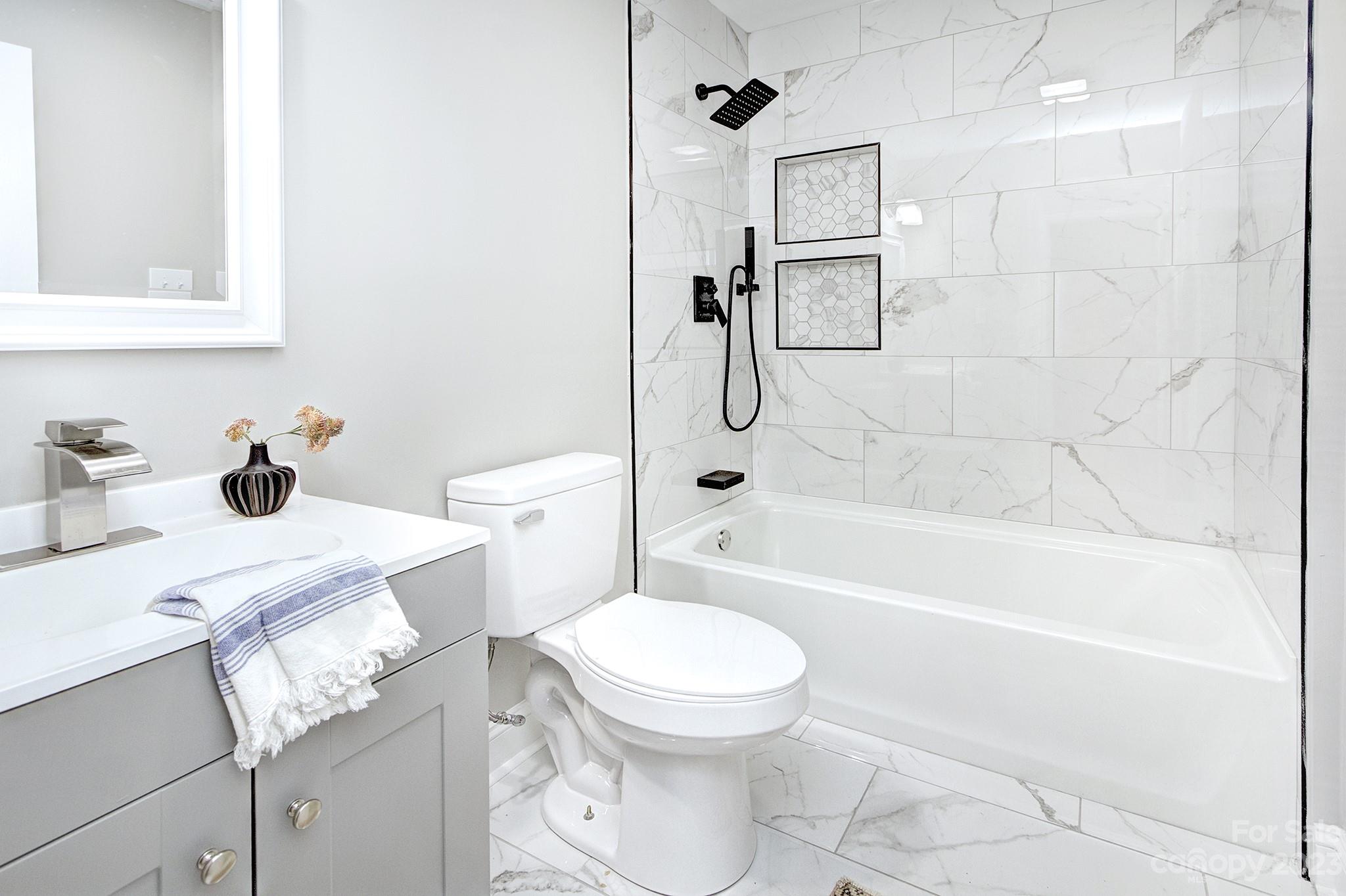 2954 Enfield Road Charlotte, NC 28205 - Photo 17 of 27 a bathroom with a sink toilet and shower