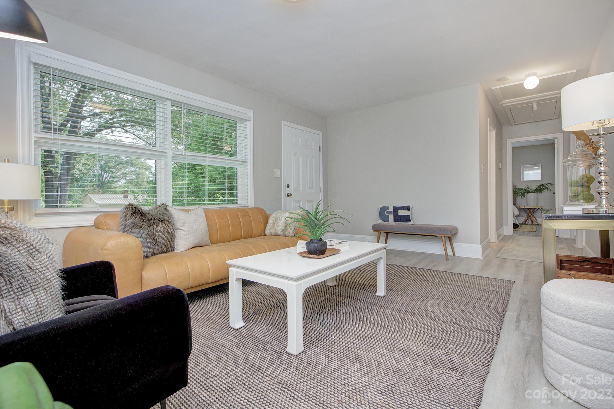 2954 Enfield Road Charlotte, NC 28205 - Photo 2 of 27 a living room with furniture and a large window