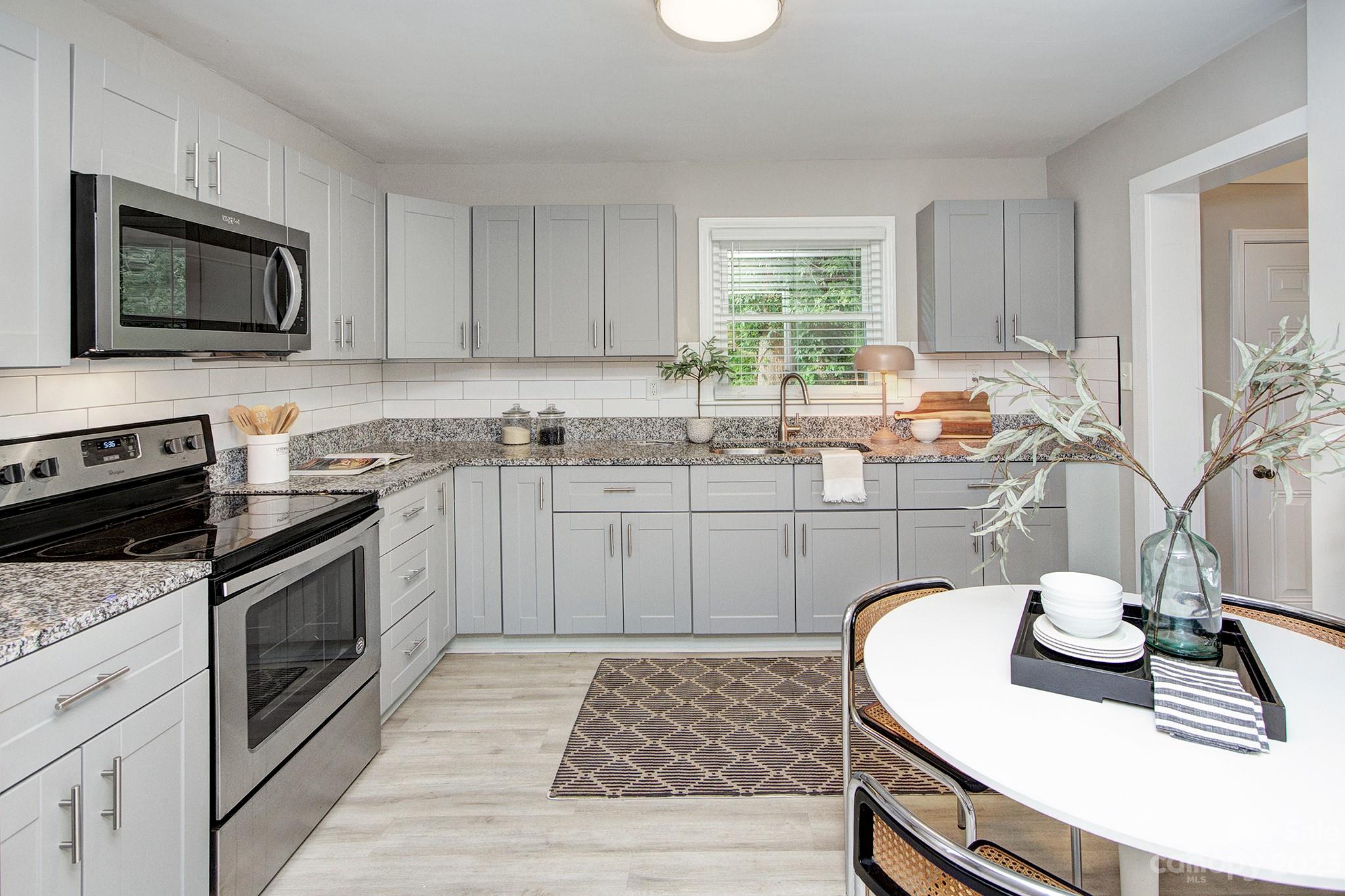 2954 Enfield Road Charlotte, NC 28205 - Photo 6 of 27 a kitchen with a sink stove and microwave