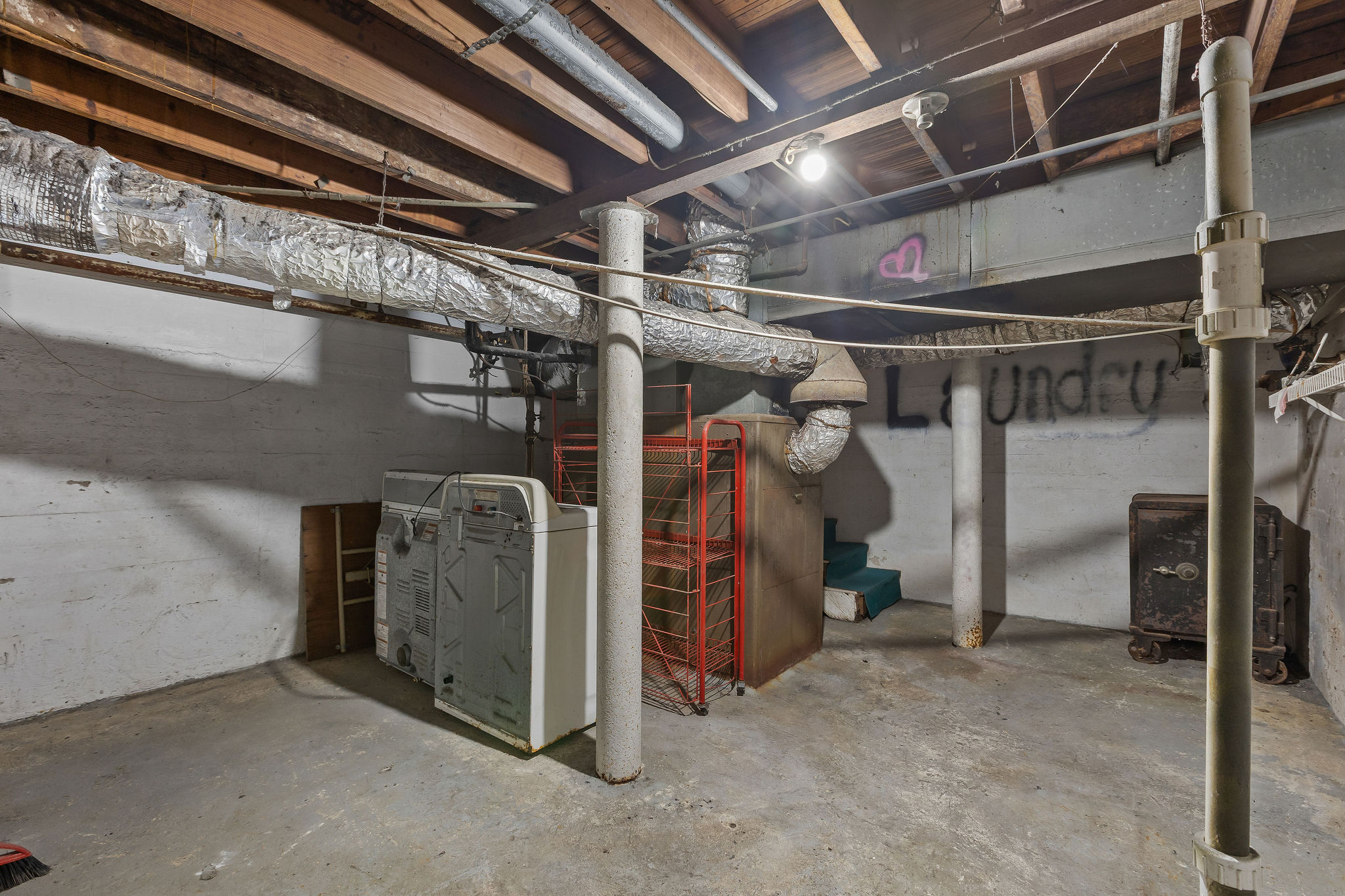 948 Maple Street Lockhart, TX 78644 - Photo 32 of 40 A rare basement, approximately half the footprint of the home, contains an antique safe and currently serves as the laundry area, providing valuable functional space seldom found in homes of this era.