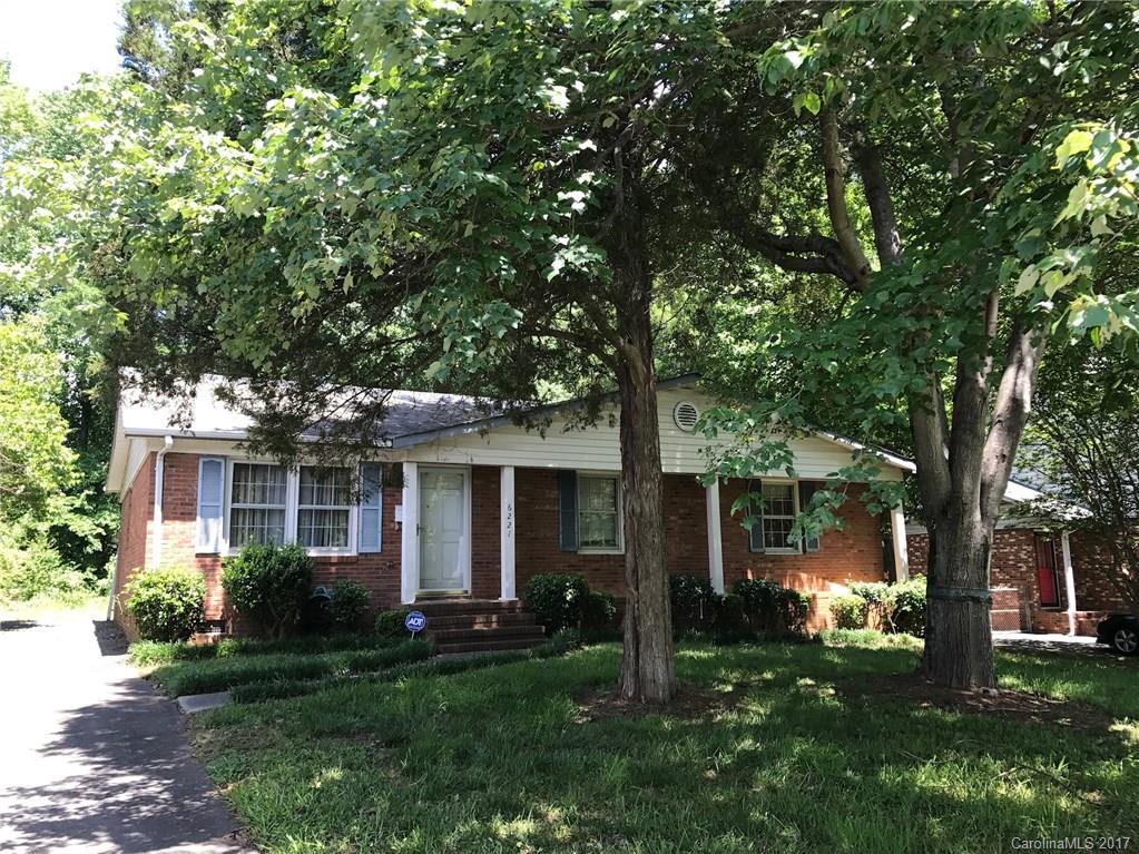 6221 Old Coach Road Charlotte, NC 28215 - Photo 2 of 9 a front view of house with a garden and trees