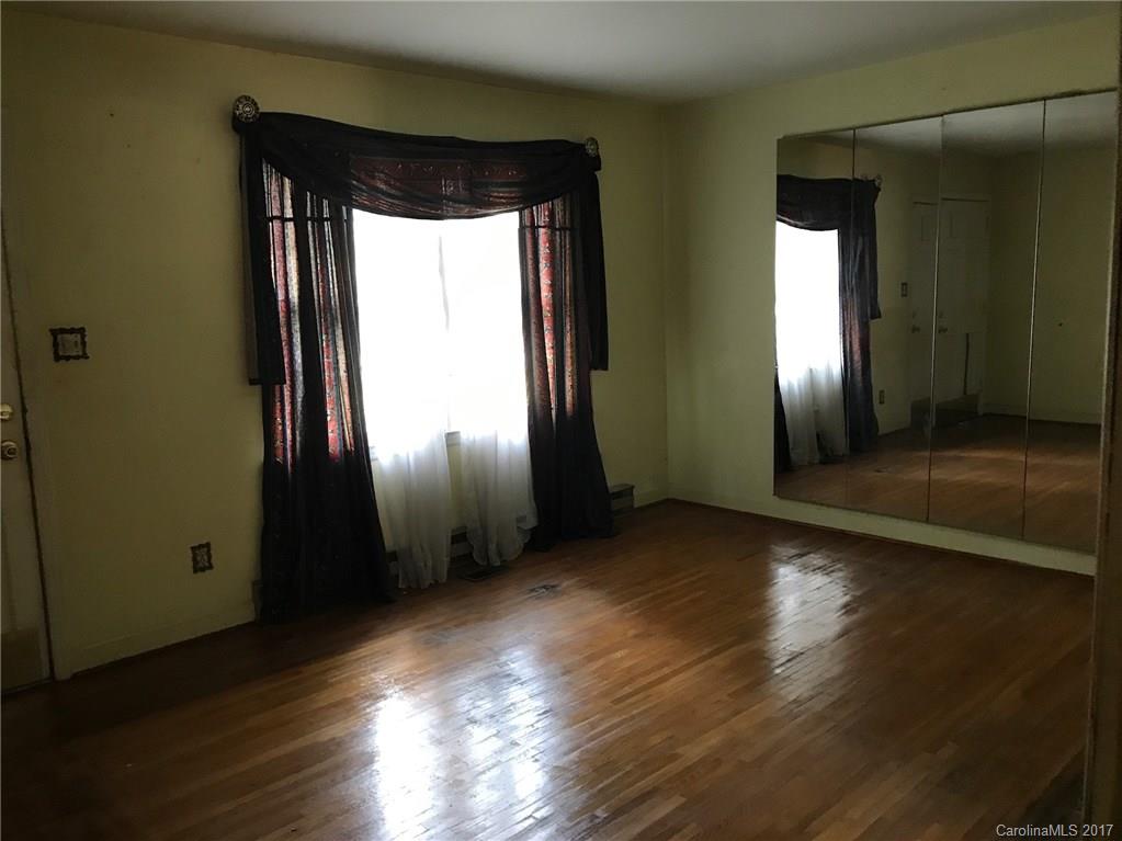 6221 Old Coach Road Charlotte, NC 28215 - Photo 4 of 9 an empty room with wooden floor and windows