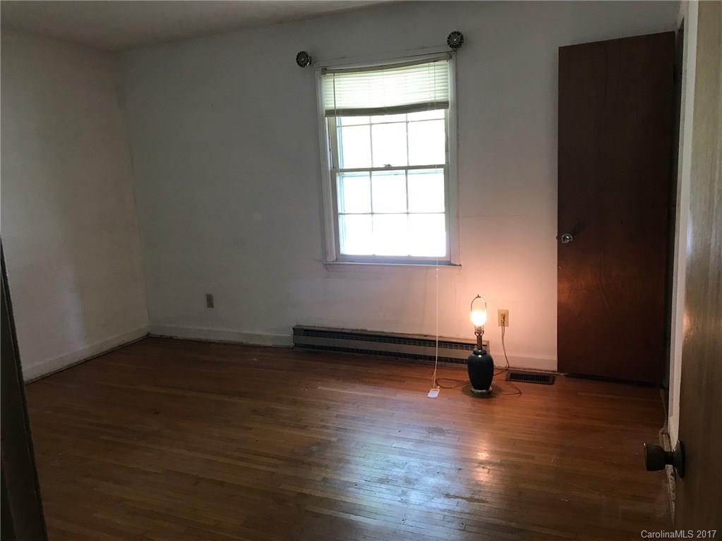 6221 Old Coach Road Charlotte, NC 28215 - Photo 8 of 9 an empty room with wooden floor and a window