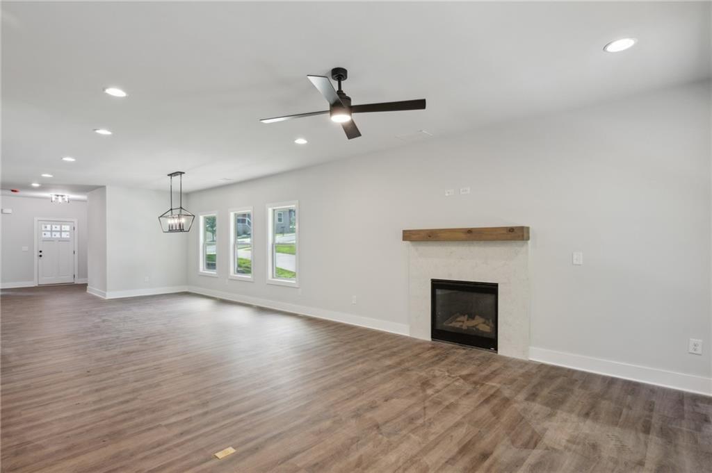 3131 Stonegate Drive Atlanta, GA 30331 - Photo 15 of 28 an empty room with wooden floor fireplace and windows