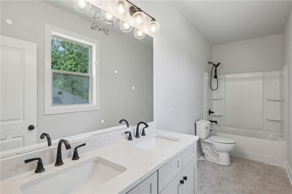 3131 Stonegate Drive Atlanta, GA 30331 - Photo 20 of 28 a bathroom with a sink a toilet and shower