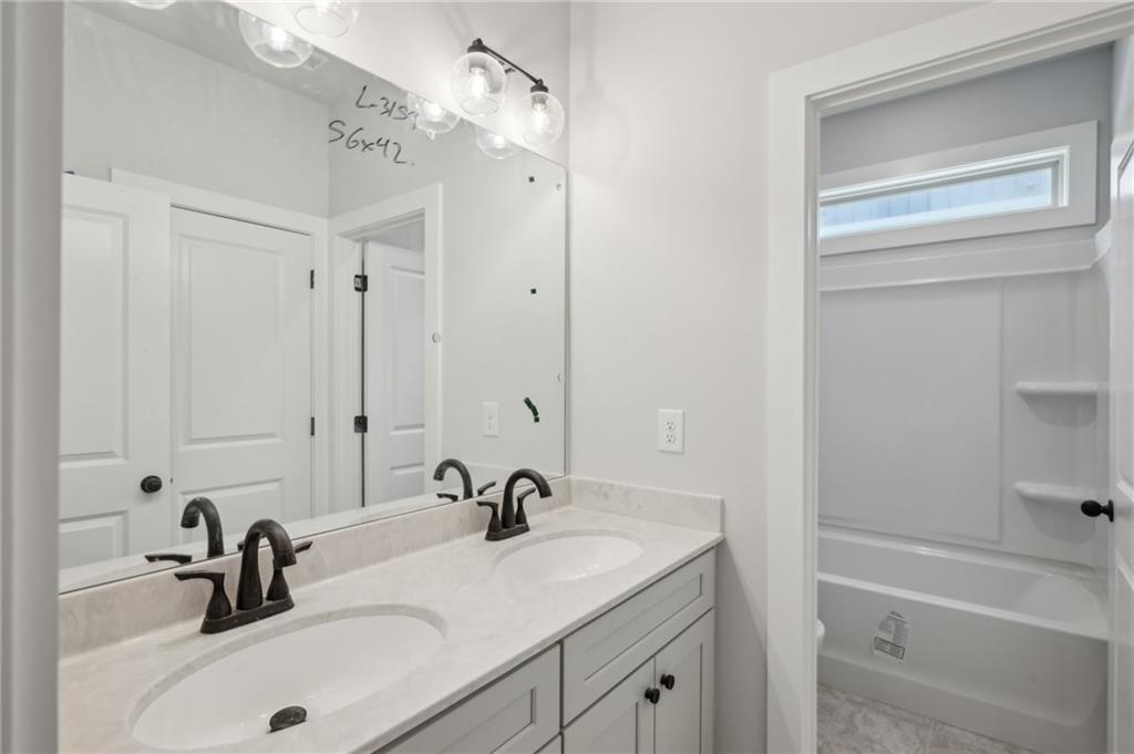 3131 Stonegate Drive Atlanta, GA 30331 - Photo 22 of 28 a bathroom with a sink a tub and a mirror