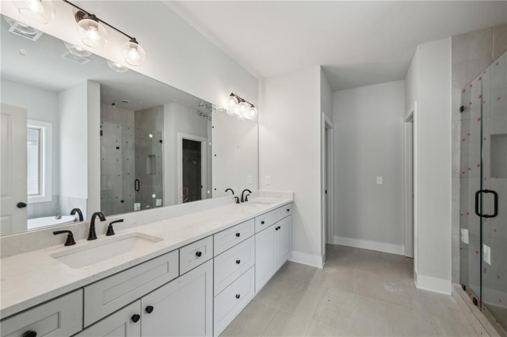 3131 Stonegate Drive Atlanta, GA 30331 - Photo 4 of 28 a bathroom with a double vanity sink mirror double and shower